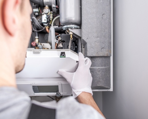 Close Up Of Caucasian Service Worker Fixing Central Heating Furnace System