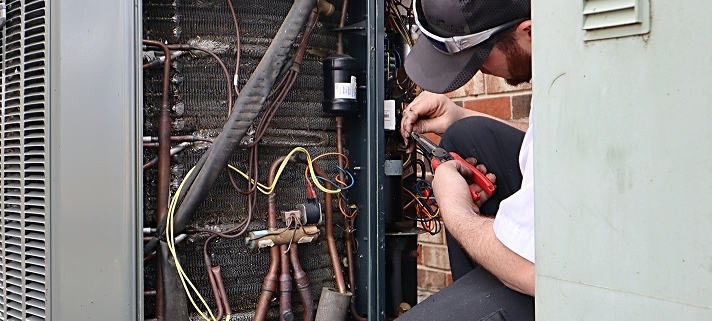 service-repair-being-done-on-a-heat-pump-hvac-syst-Kay Heating