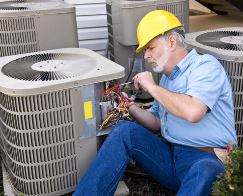 man providing maintenance to HVAC system